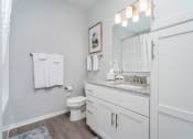 Thumbnail 8 of 30 - a white bathroom with a large mirror and a toilet