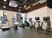 Thumbnail 23 of 29 - a gym with various exercise equipment on the floor and a window