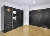 Thumbnail 28 of 29 - a room with black lockers on the wall and a wooden floor