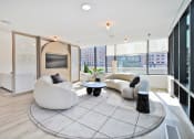 Thumbnail 3 of 29 - a living room with two white chairs and a television