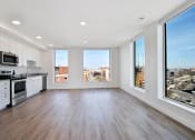 Thumbnail 18 of 29 - an open kitchen and living room with a view of the city