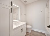 Thumbnail 18 of 38 - a bathroom with a sink and a toilet and a mirror