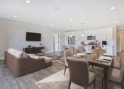 Thumbnail 4 of 38 - a living room and dining room with a table and chairs