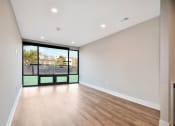 Thumbnail 12 of 38 - the living room of a new home with a large window and wooden floors