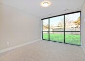 Thumbnail 13 of 38 - an empty living room with a view of a yard and window