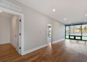Thumbnail 14 of 38 - a living room with a hard wood floor and a door to a balcony