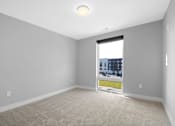 Thumbnail 31 of 38 - A room with a window showing a cityscape outside.