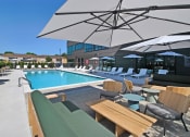 Thumbnail 27 of 38 - a swimming pool with lounge chairs and umbrellas at a hotel