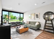 Thumbnail 2 of 38 - a living room with a couch and chairs and a large window