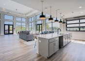 Thumbnail 24 of 29 - a large kitchen with a large island and a living room