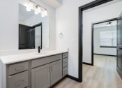 Thumbnail 22 of 29 - a white bathroom with a large mirror and a sink