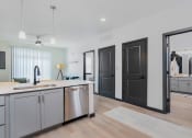 Thumbnail 3 of 29 - an open kitchen and living room with a sink and a counter