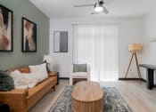 Thumbnail 6 of 29 - a living room with a couch and a table