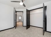 Thumbnail 15 of 29 - a bedroom with a closet and a ceiling fan