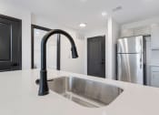 Thumbnail 12 of 29 - kitchen sink and a stainless steel fridge