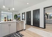 Thumbnail 4 of 50 - A modern kitchen with wooden floors and a large island.