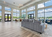 Thumbnail 24 of 50 - A spacious living room with a grey sofa and wooden flooring.