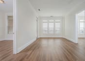 Thumbnail 6 of 40 - a bedroom with hardwood floors and white walls