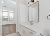 Thumbnail 24 of 40 - a bathroom with a sink and a mirror