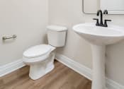Thumbnail 25 of 40 - a bathroom with a toilet sink and mirror