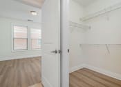 Thumbnail 9 of 40 - a bedroom with white walls and hardwood floors