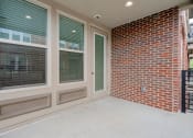 Thumbnail 31 of 40 - a covered patio with a brick wall