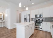 Thumbnail 1 of 40 - a kitchen with white cabinets and stainless steel appliances