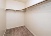 Thumbnail 14 of 29 - an empty room with a wall hung closet and a carpet