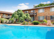 Thumbnail 26 of 29 - a large swimming pool in front of a building