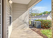 Thumbnail 12 of 42 - A sunny day at a residential house with a covered porch.