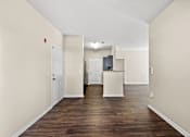 Thumbnail 13 of 42 - A long hallway with a white door on the left and a white door on the right.