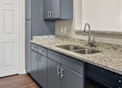 Thumbnail 15 of 42 - A kitchen with a sink and cabinets.