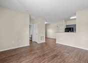 Thumbnail 16 of 42 - A room with wooden floors and white walls.