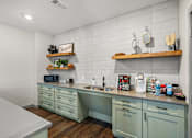 Thumbnail 25 of 42 - A kitchen with green cabinets and a white countertop.