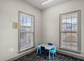 Thumbnail 29 of 42 - A room with a table and chairs by the window.