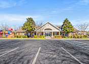 Thumbnail 41 of 42 - A large building with a parking lot in front of it.