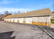 Thumbnail 39 of 42 - A building with a brown roof and a red sign on it.