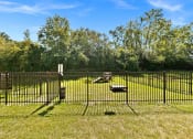 Thumbnail 27 of 38 - a yard with a fence and benches in the grass