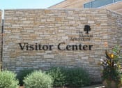Thumbnail 33 of 38 - a brick building with a visitor center sign on it