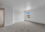 Thumbnail 22 of 38 - a bedroom with white walls and carpet