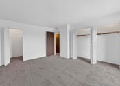 Thumbnail 23 of 38 - a bedroom with white walls and carpet