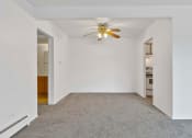 Thumbnail 19 of 38 - a bedroom with white walls and a ceiling fan