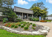 Thumbnail 14 of 45 - A small building with a landscaped garden in front.