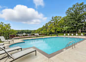 Thumbnail 11 of 45 - A large outdoor swimming pool surrounded by lounge chairs.