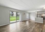 Thumbnail 16 of 45 - A spacious room with wooden flooring and a reception desk.