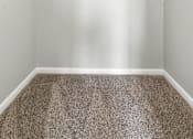 Thumbnail 33 of 45 - A room with a carpeted floor and two white shelves.