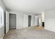 Thumbnail 44 of 45 - A spacious room with white walls and carpeted floor.