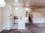 Thumbnail 16 of 29 - A kitchen area with a refrigerator, cabinets, and a stove top oven.