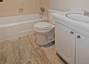 Thumbnail 15 of 29 - a bathroom with a toilet and a tub and a sink