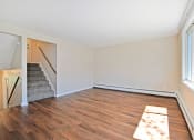 Thumbnail 6 of 29 - an empty living room with wood flooring and a staircase
